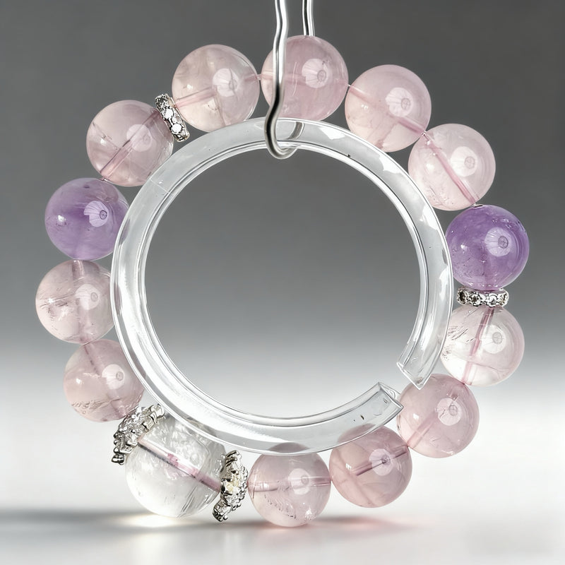 Handcrafted rose quartz, amethyst, and clear quartz crystal bracelet on a clear background, created to support love, emotional harmony, and romantic reconnection.