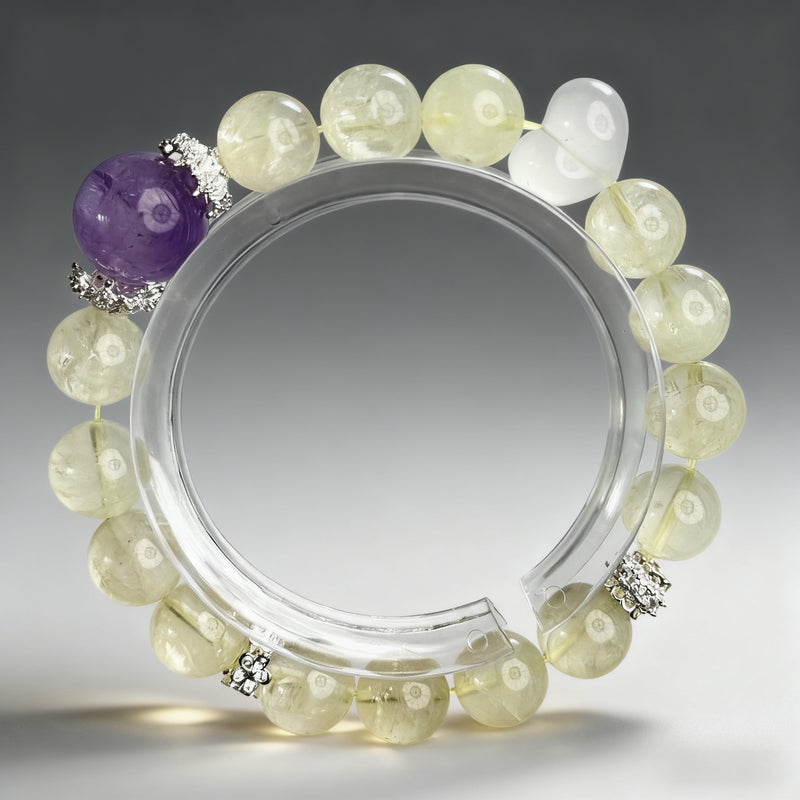 Handcrafted citrine, clear quartz, and amethyst crystal bracelet on a clear background, created to support vitality, balance, and mental clarity.