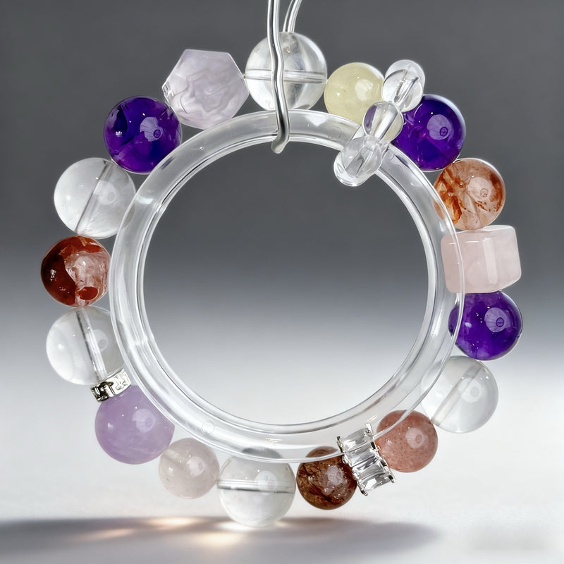 Handcrafted amethyst, clear quartz, citrine, rose quartz, red agate, and strawberry quartz crystal bracelet on a clear background, created to support creative focus, inspiration, and academic expression.