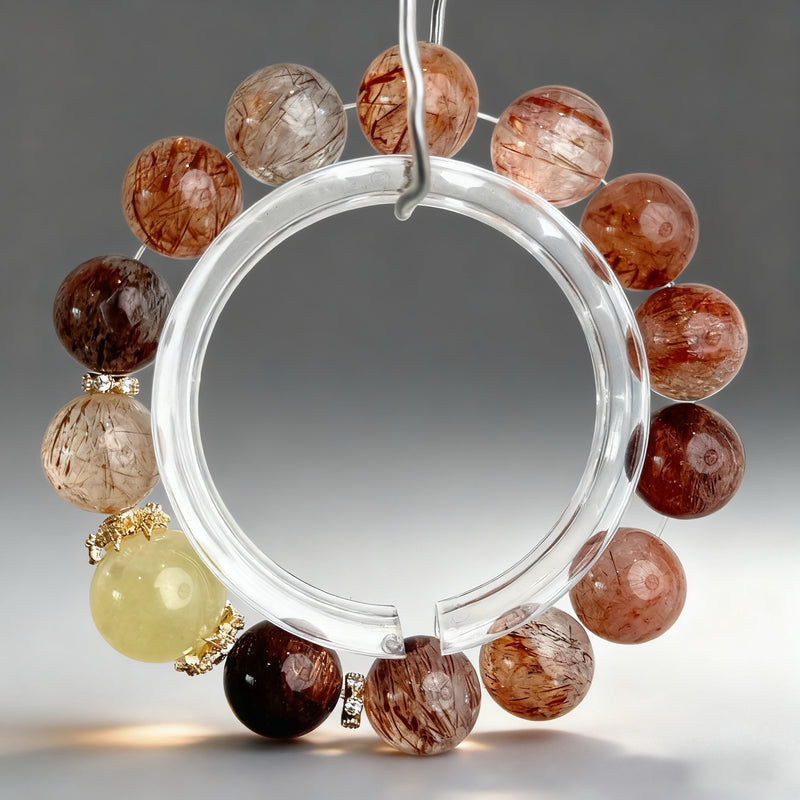 Handcrafted citrine, red rutilated quartz, and black rutilated quartz crystal bracelet on a clear background, created to support leadership confidence, protection, and breakthrough momentum.