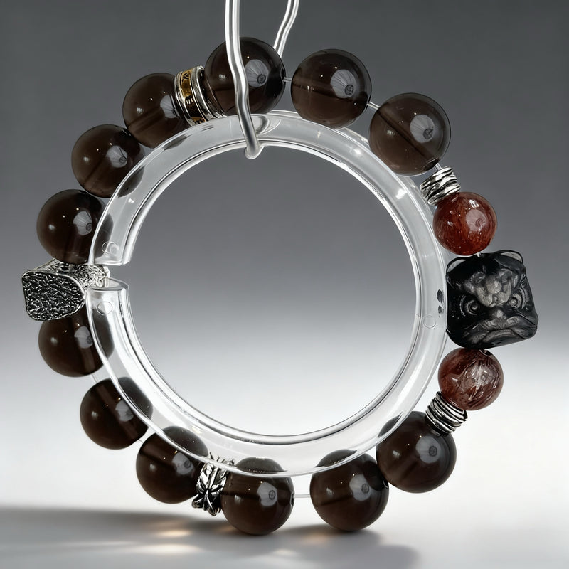 Handcrafted red rutilated quartz and smoky quartz crystal bracelet on a clear background, created to support ambition, stress resilience, and confident professional presence.