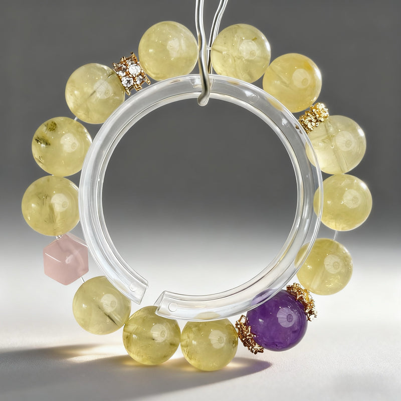 Handcrafted citrine, rose quartz, and amethyst crystal bracelet on a clear background, created to support romantic harmony, emotional balance, and gentle confidence.