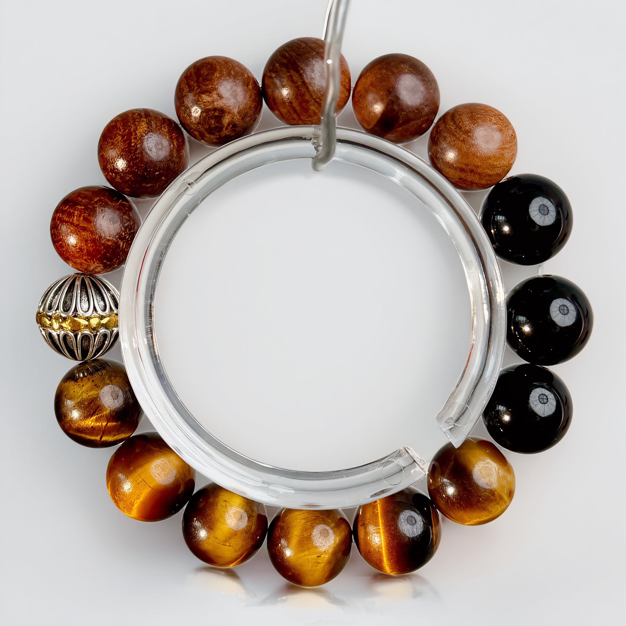 Handcrafted brown and golden tiger’s eye bracelet with deep-toned gemstones and refined metallic details, embodying warmth, strength, and steady momentum.