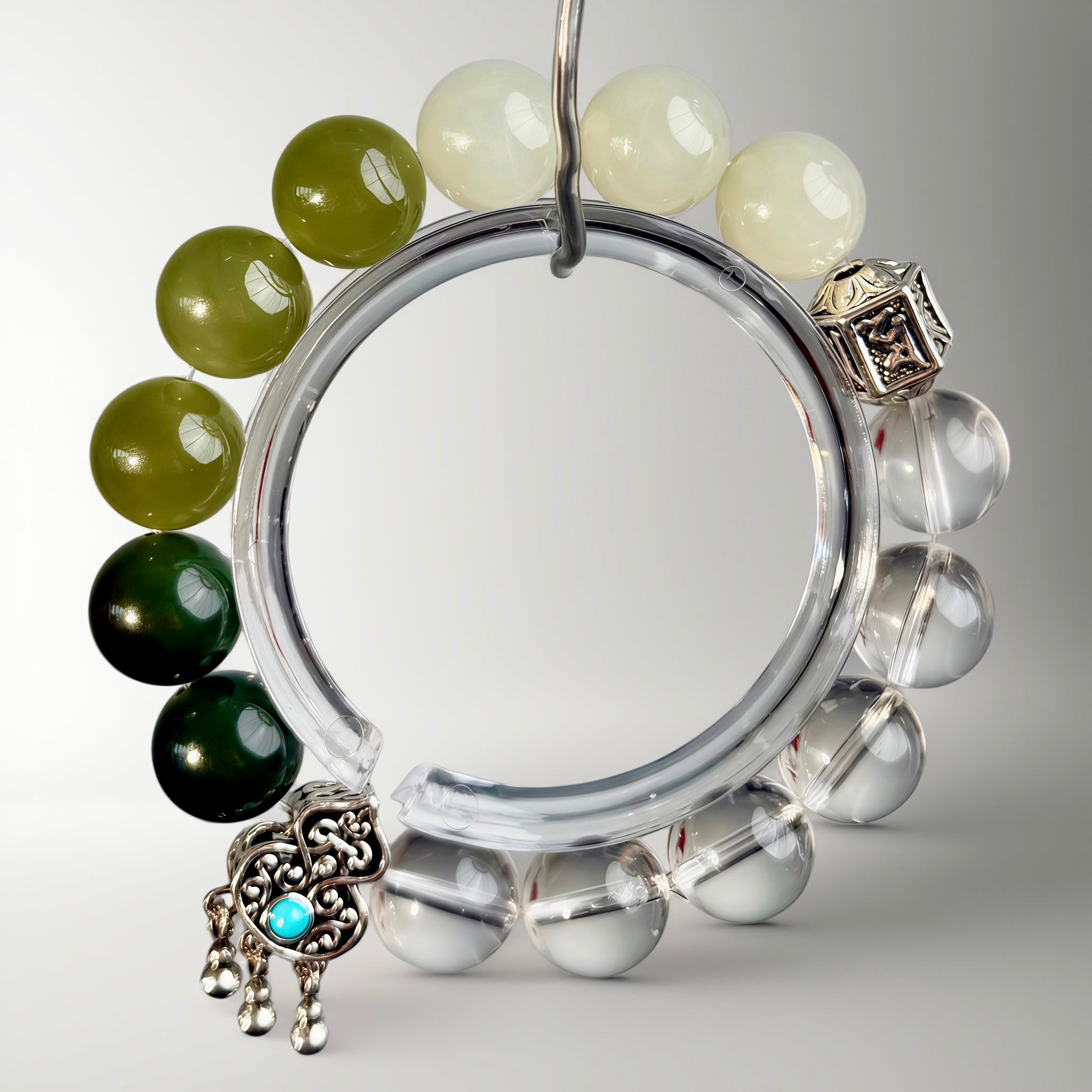 Handcrafted gradient bracelet combining Hetian jade and clear crystal, accented with turquoise gourd and mantra bead, embodying protection, clarity, and inner balance.